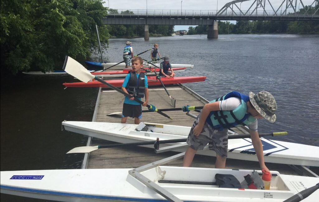 small kids in various size boats